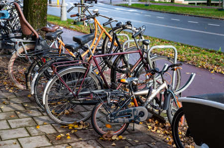 City life and transportation in Netherlands, bicycle parking in old part of sunny Amsterdan