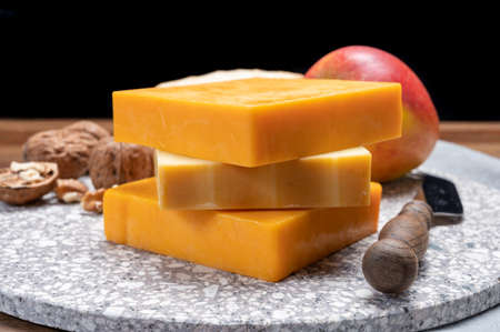 Cheese collection, orange and yellow smoked British cheese from England close up