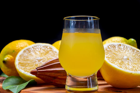 Glass of ice cold sweet limoncello liqueur made from new harvest of fresh ripe yellow Italian lemons, Amalfi coast, Italyの写真素材