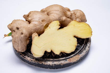Fresh organic ginger rhizome root used in traditional medicines and for flavoring meals, drinks,...
