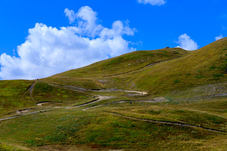 Hiking near ski station Les deux Alpes and view on Alpine mountains peaks in summer, Les Ecrins...