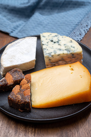 Cheese collection, blue cheese, camembert, brie served as dessert with fig almonds bread close upの写真素材