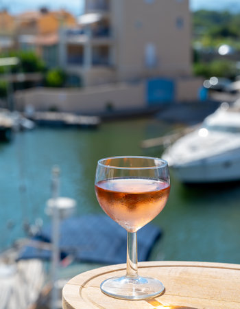 Tasting of local cold rose wine in summer with sail boats haven of Port grimaud on background, Provence, Var, Franceの写真素材
