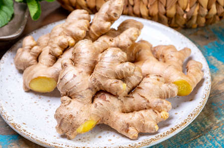 Fresh organic ginger roots, healthy food ingredient close up