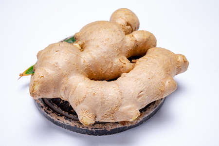 Fresh organic ginger rhizome root used in traditional medicines and for flavoring meals, drinks,...