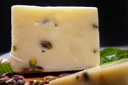 Cheese collection, fresh Italian pecorino cheese made from sheep milk filled with pistachio nuts from Bronte, Sicily close upの写真素材