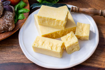 Cheese collection, pieces of aged British cheddar cheese close upの写真素材