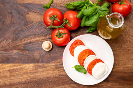 Tasty italian vegetarian food, fresh soft white mozzarella cheese served with red tomatoes and green basil c; pse upの写真素材