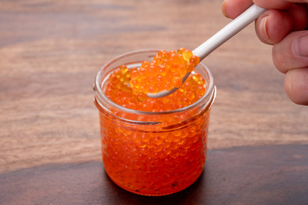Tasty sea food, high quality red trout fish caviar in glass jarの写真素材