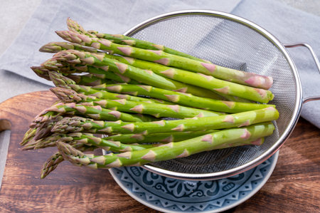 Bunch of fresh ripe green asparagus organic vegetables ready to cook or grillの写真素材