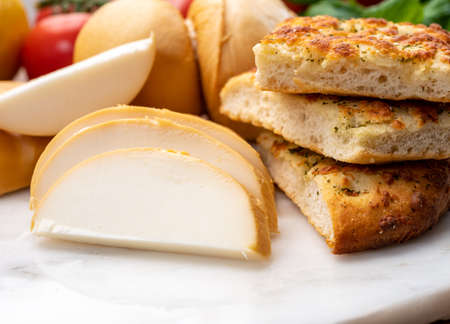 Cheese collection, Italian yellow smoked caciocavallo or scamorza cheese from Pugliaの写真素材