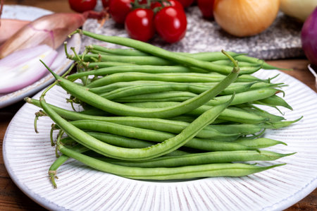 Fresh uncooked green beans haricot verts legumes close up