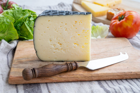 Cheese collection, French fol epi cheese with many little holes, etorki, tomme noire des pyrenees...