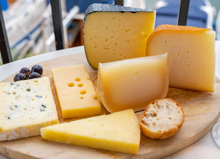 Cheese collection, French fol epi cheese with many little holes, etorki, tomme noire des pyrenees...