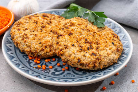 Healthy vegetarian or vegan food, meat free burger made from orange lentils legumes close up