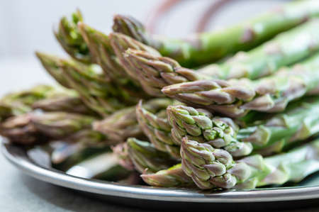 Bunch of fresh ripe green asparagus organic vegetables ready to cook or grillの写真素材