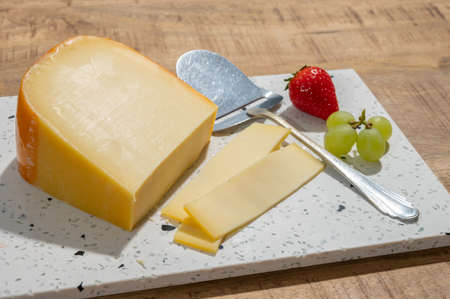 Cheese collection, piece of young Dutch gouda cheese made from cow milk in Netherlands close up