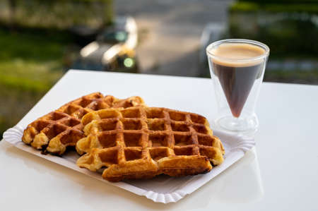 Belgian sugar waffles from Brussels with black coffee served outdoorの写真素材