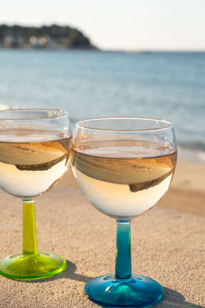Summer time in Provence, drinking of cold dry gris rose wine on sandy beach and blue sea near Toulon, Var department, Franceの写真素材