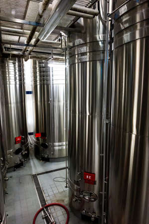 Traditional champagne sparkling wine making process in steel tanks in underground caves near...
