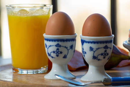 Continental breakfast with soft-boiled chicken egg served outdoor in summer