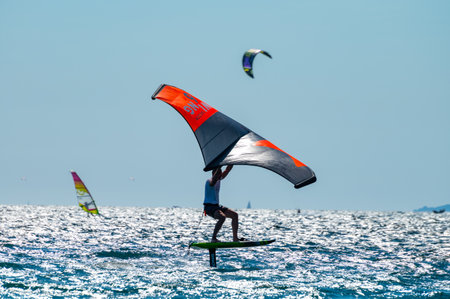 2021. Extreme water sports - wing foil, kite surfing, wind surfindg, windy day on Almanarre beach near Toulon, South of Franceのeditorial素材