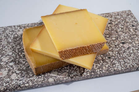 Cheese collection, hard French cheese comte made from cow milk with rind in Franche-Comte region, France close upの写真素材