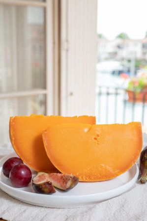 Cheese collection, French yellow cheese mimolette made from cow milk served with fresh figsの写真素材