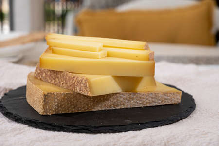 Cheese collection, hard French cheese comte made from cow milk with rind in Franche-Comte region, France close upの写真素材
