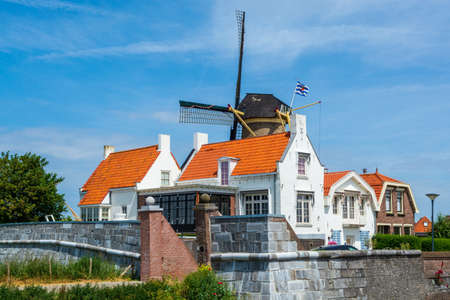 Walking in old Dutch town Zierikzee with old windmill, small houses and streets, Zeeland, Netherlandsの写真素材