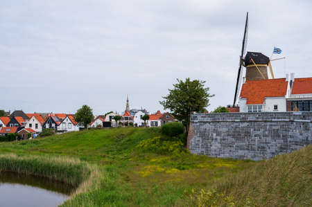 Walking in old Dutch town Zierikzee with old windmill, small houses and streets, Zeeland, Netherlandsの写真素材