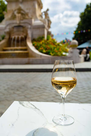 Drinking of brut champagne sparkling wine in street cafe with view on old central part of city Reims, Champagne, Franceの写真素材