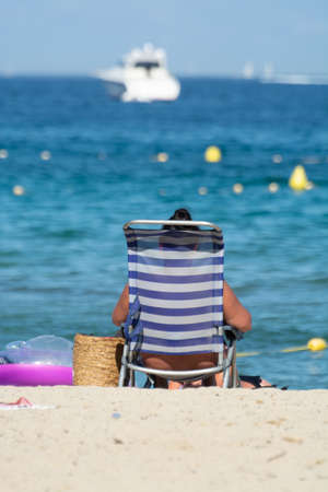 Unidentified people sunbathing on sandy beach on French Riviera, Var, summer vacation on sea, Franceの写真素材