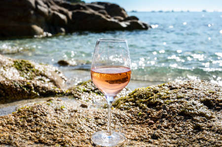 Summer time in Provence, glass of cold rose wine on sandy beach near Saint-Tropez in sunny day, Var department, Franceの写真素材
