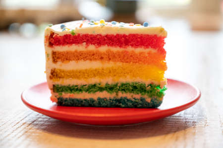 Piece of fresh baked colorful birthday cake close upの写真素材
