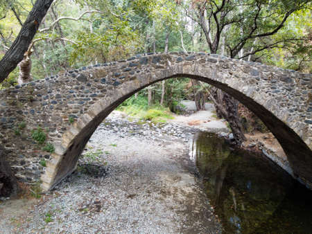 Medieval venetian stone arch bridge located in green Troodos mountains, Cyprusの写真素材