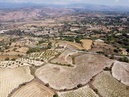 Aerial view on Troodos mountains, fertile valley with vineyards and olive groves, villages and white roads, Cyprusの写真素材