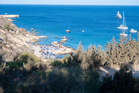 Crystal clear blue water of Mediterranean sea and yellow rocks in on sandy Konnos beach near Protaras, Cyprusの写真素材