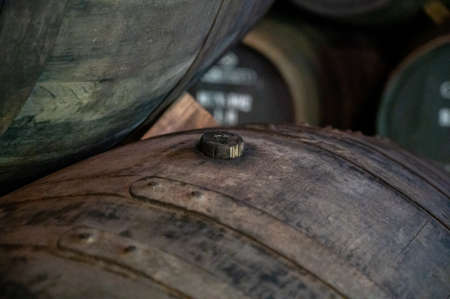 Old porto lodge with rows of oak wooden casks for slow aging of fortified ruby or tawny porto wine in Vila Nova de Gaia, north of Portugalの写真素材