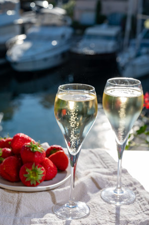 Summer party, drinking of French brut champagne sparkling wine in glasses in yacht harbor of Port Grimaud near Saint-Tropez, French Riviera vacation, Franceの写真素材