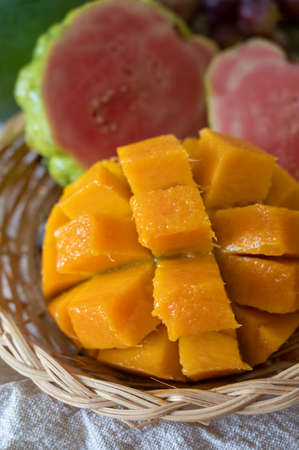 Exotic fruits of Cyprus, fresh yellow juicy mango, ripe pink guava, bananas and sweet table grapes teady to eatの写真素材