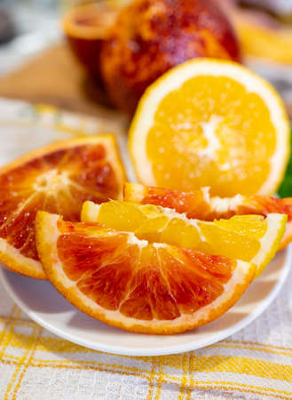 Sicilian sweet juicy yellow and red blood oranges with green leaves close-upの写真素材