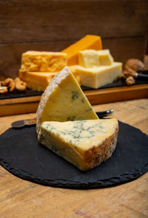 British cheeses collection, blue Stilton, Scottish colored and English matured cheddar cheesesの写真素材