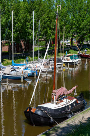 Walking on old streets of Harlingen fisherman town on Wadden sea, Friesland, Netherlands in sunny dayの写真素材