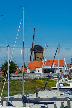 Walking in old Dutch town Zierikzee with old windmill, small houses and streets, Zeeland, Netherlandsの写真素材