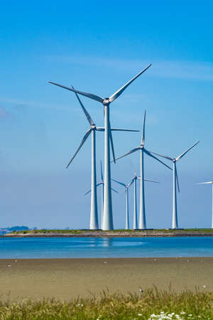 Windmills energy park in Zeeland, Netherlands, industrial landscape in summer day