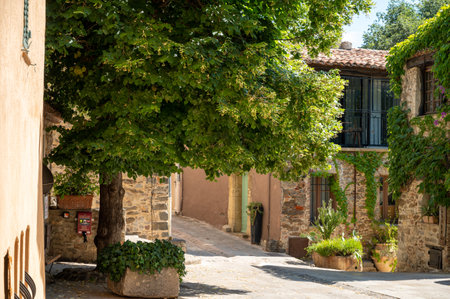 Walking in sunny day on ancient french village Grimaud, touristic destination with ruins fortress castle on top, Var, Provence, Franceのeditorial素材