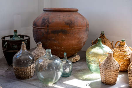 Wine industry of Cyprus island, collection of old wine fermenting glass jugs and bottles for making wine on ancient winery in Troodos mountain range.の写真素材