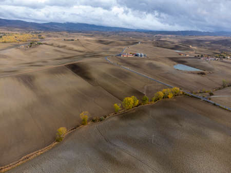 Aerial view on hills of Val d'Orcia, Tuscany, Italy. Tuscan landscape with plowed fields in cloudy autumn.の写真素材