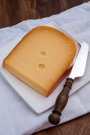 Dutch hard cow milk old yellow cheese from Goudaの写真素材